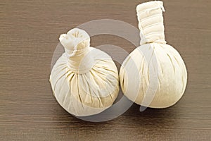 Spa herbal compressing ball on black wooden background