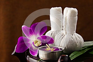 Spa herbal compressing ball with candles and orchid