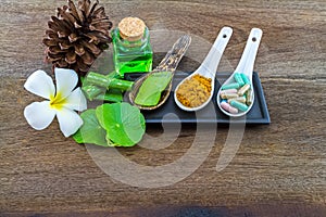 Spa herbal white frangipani flowers, turmeric powder in white spoon ,pill,Aloe vera essential oil and gel,Green Asiatic Pennywort