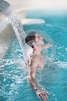 Spa hydrotherapy man waterfall jet turquoise photo
