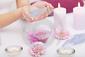 Spa Manicure. Woman Hands With Perfect Natural Healthy Nails Soaking In Aroma Hand Bath. Closeup Of Glass Bowl With Water And Blu