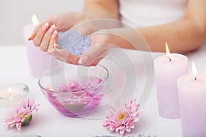 Spa Manicure. Woman Hands With Perfect Natural Healthy Nails Soaking In Aroma Hand Bath. Closeup Of Glass Bowl With Water And Blu