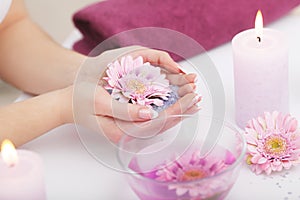 Spa Manicure. Woman Hands With Perfect Natural Healthy Nails Soaking In Aroma Hand Bath. Closeup Of Glass Bowl With Water And Blu