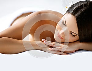 Spa Massage. Beautiful Young Woman Relaxing after Massage.