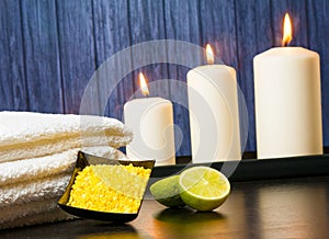 Spa massage border background with towel stacked candles sea salt and lime
