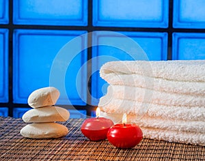 Spa massage border background with towel stacked stone and red candles warm atmosphere