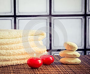 Spa massage border background with towel stacked stone and red candles warm atmosphere