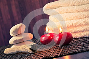Spa massage border background with towel stacked stone and red candles warm atmosphere