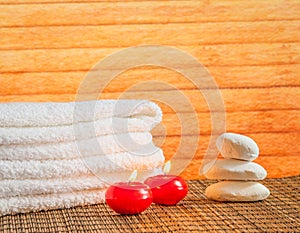 Spa massage border background with towel stacked stone and red candles warm atmosphere