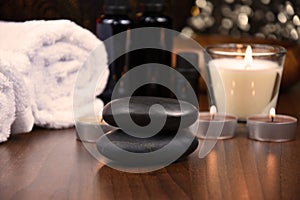 Spa massage hot stones, white towels and candles on wooden background still life stock photo images