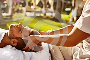 Spa Massage. Man Enjoying Relaxing Head Massage Outdoors. Beauty