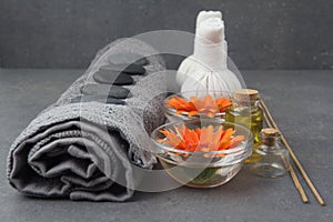 Spa massage setting with rolled towel, thai herbal compress balls and flowers