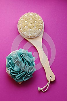 Spa massage wooden body brush on purple background