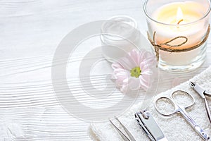 Spa nail care with aroma candle on wooden background