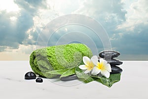 Spa objects towel, flowers. stones, leaves for healthy therapy