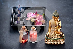 Spa with orchids, Buddha statue, sea salt, incense and bath oils