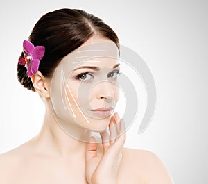 Spa portrait of a young and healthy woman with arrows on her face