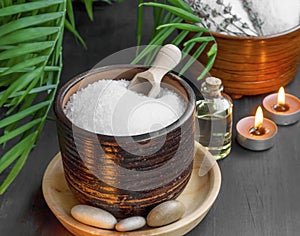 Spa products with bath salt, bath oil, massage stones and candle