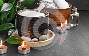 Spa products with bath salt, bath oil, massage stones and candle