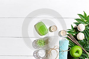 Spa products. Bath salts, soap, candles and towel. Flat lay on white wooden background, top view.