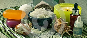 Spa products on wooden background Bowl with sea salt, seashells