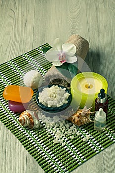 Spa products on wooden background Orchid flower, bowl with sea