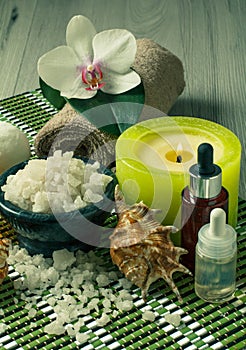 Spa products on wooden background Orchid flower, bowl with sea