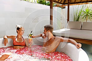 Spa Relax. Couple In Love In Flower Bath Drinking Drinks