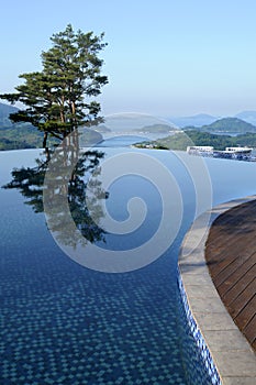 Spa resort hotel infinity swimming pool, healthy lifestyle summer vacation vertical