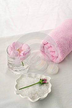 Spa resort therapy composition. Candles, rose flower, salt, towel. Relax, wellness and mindfulness concept.