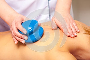 Spa salon. Woman relaxing having cupping-glass massage. Bodycare. photo