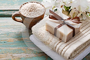 Spa set: bar of handmade natural soap lying on the towels