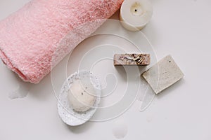 Spa set. Bar of handmade soap, candle and towel. Accessories for personal hygiene. Decor for bathroom interior