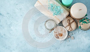 Spa set with care products on a soft blue background. Side view, panorama.