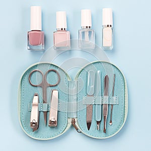 Spa set, manicure or pedicure equipment with nail coat or polish, on blue background, top view, square format