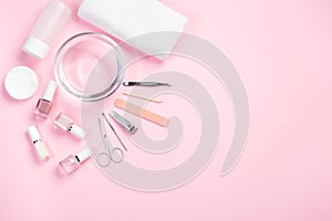 Spa set, manicure or pedicure equipment with nail coat or polish, on pink background, horizontal, copy space, top view