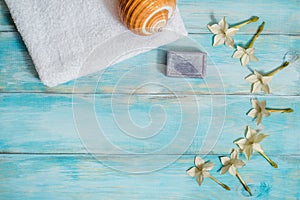 Spa set with sea shells and salt on blue wooden old background. Sea holidays, relaxation, aromatherapy. Sea Star and White Lotus