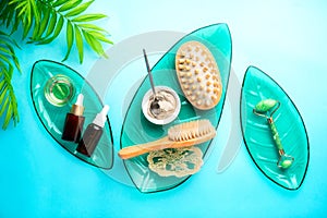 Spa setting background with cosmetic clay and jade roller