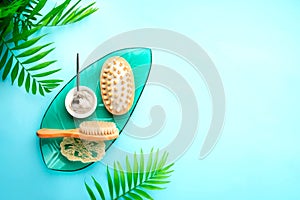 Spa setting background with cosmetic clay and massage brushes