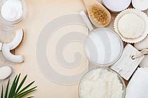 Spa setting from body care, wellness and beauty treatment. Coconut scrub, oil and cream on stone table top view.