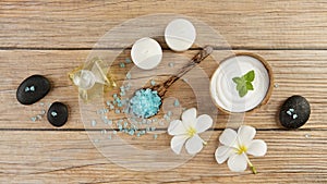 Spa setting concept with oil bottle, blue salt sea in spoon, min