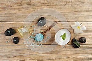 Spa setting concept with oil bottle, blue salt sea in spoon, min