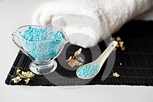 Spa setting with flower and towel on a bamboo black background.