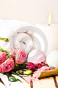 Spa setting with pink roses and aroma oil, vintage style