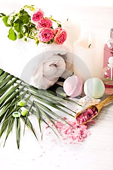 Spa setting with pink roses and aroma oil, vintage style