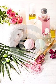 Spa setting with pink roses and aroma oil, vintage style