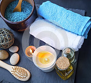 Spa setting still life with cotton towels, bath oil and salt, bu