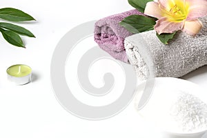 Spa setting of towel, flower, coffee beans on white background with copy space. Relax.