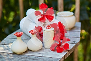 Spa setting with towels and red hibiscus flowers