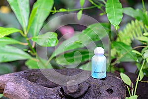 Spa shower gel on wooden stump in natural background